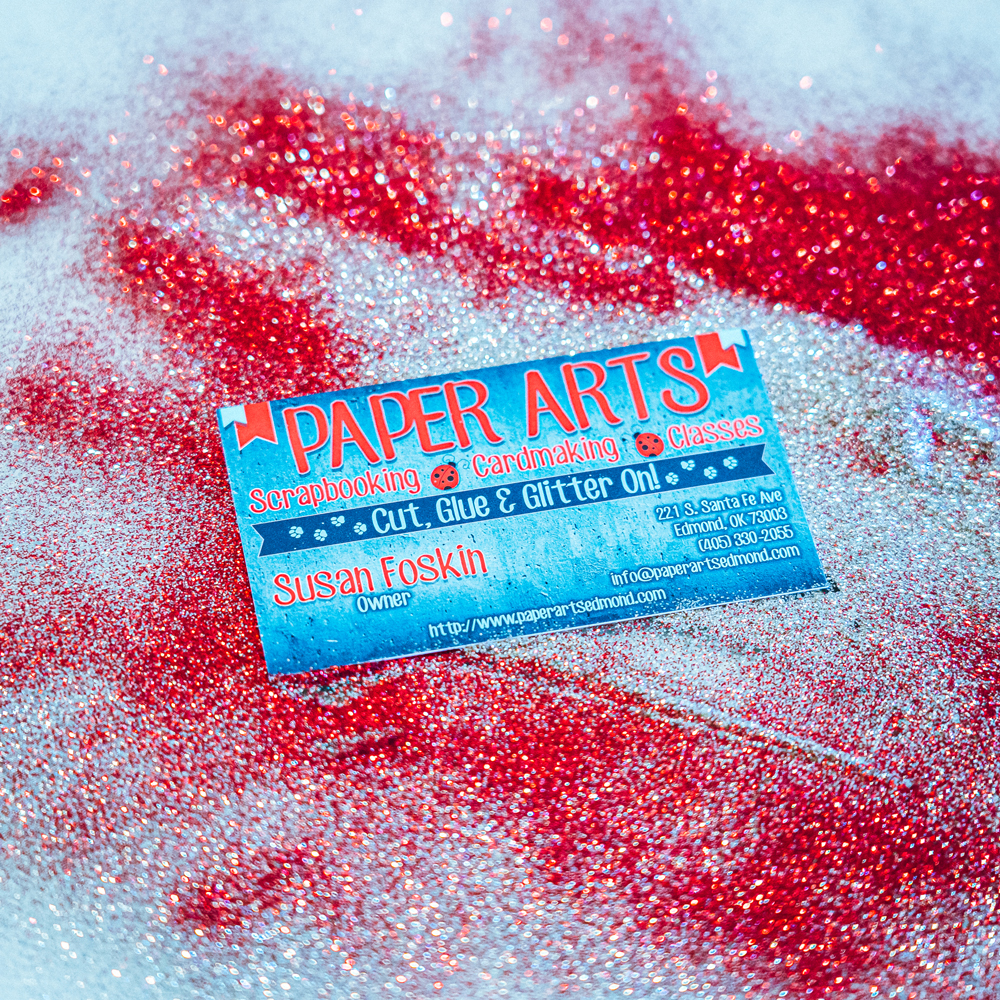 Paper Arts Business Card on top of Glitter